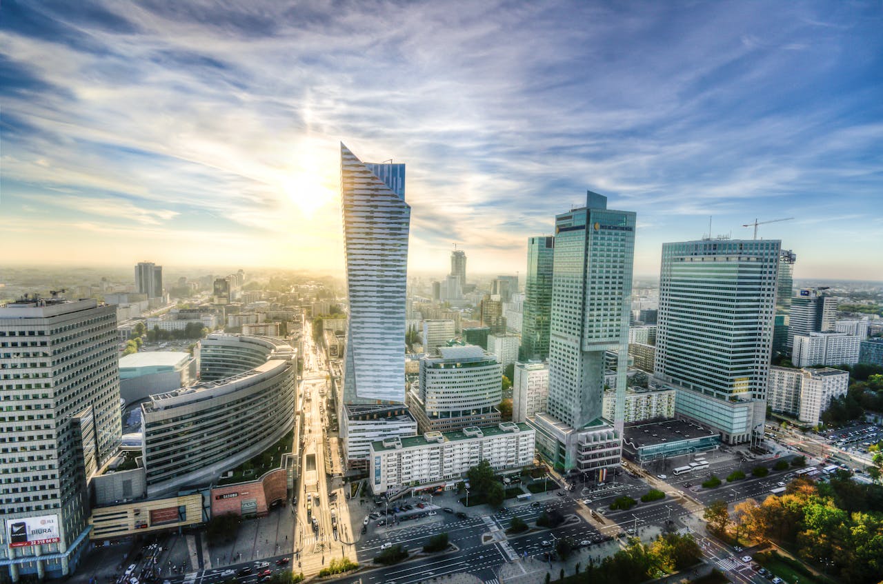 Breathtaking aerial view of Warsaw's modern skyline during sunset showcasing urban architecture.